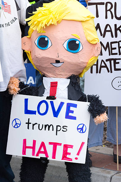 San Diego, California, USA - May 27, 2016: A Mexican pinata in the form of a smiling Donald Trump holds a sign reading \