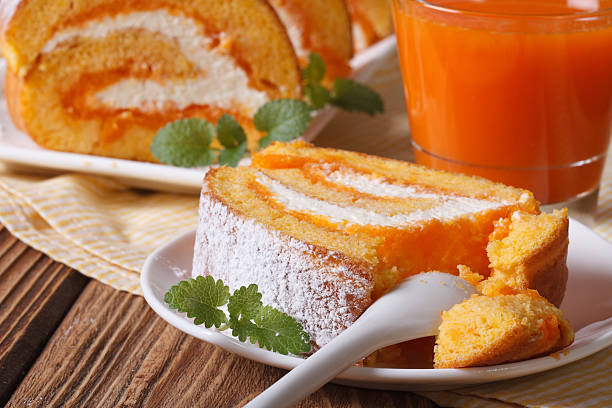 A slice of delicious carrot rolls on a plate and juice closeup. horizontal