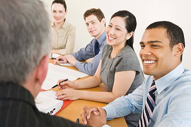 Five businesspeople in a meeting