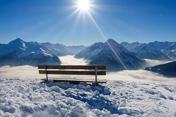 Bench with view over the winter Alps