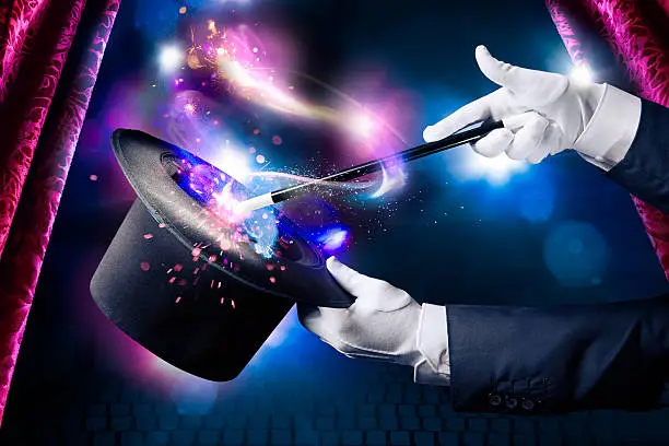 Magician hand with magic wand and hat