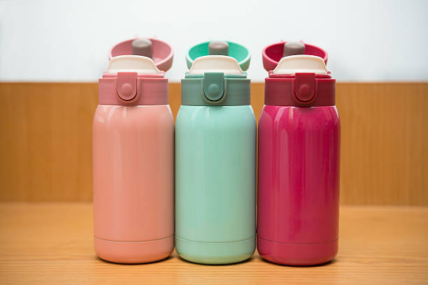 istock colorful thermos on a wooden table 537228374