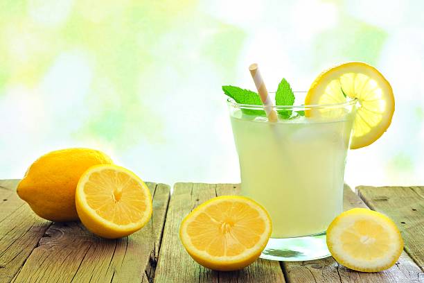 istock Lemonade on wood with lemons and defocused outdoor background 537228588