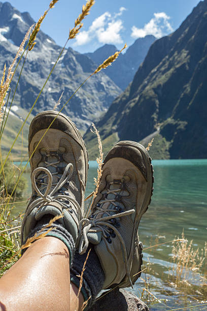 istock Woman's legs and hiking boots on rock at Lake Marian 537228796