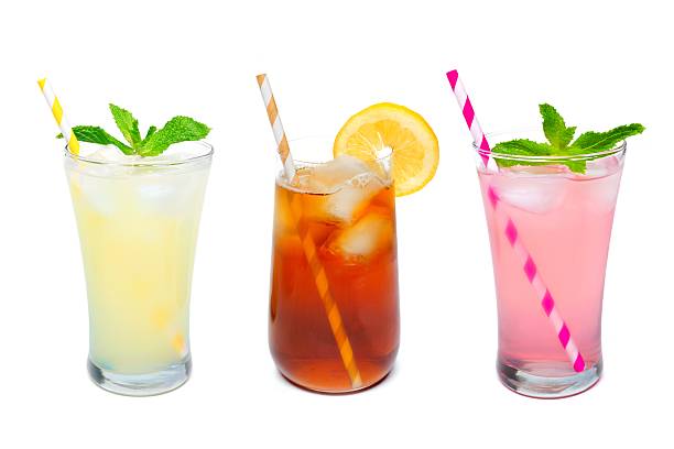 Three glasses of summer drinks with straws over white Three glasses of summer lemonade, iced tea, and pink lemonade drinks with straws isolated on a white background lemon soda photos stock pictures, royalty-free photos & images