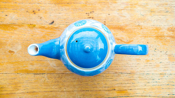 istock top view of tea pot with wood background 537233838