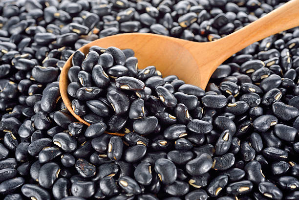 istock pile of uncooked black bean with wooden spoon 537236474