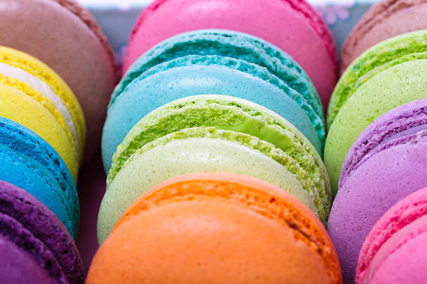collection of colorful French macarons are next to each other