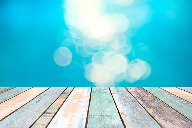 istock Wood table top and blurry blue water bokeh abstract background 537238726