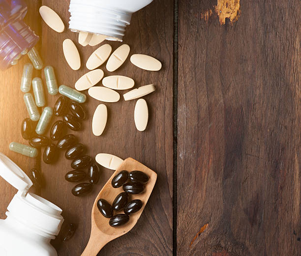 istock Medical pill on wooden table. 537239682