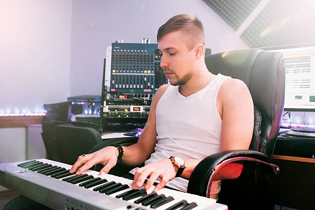 istock DJ plays on electronic piano in the studio 537239872