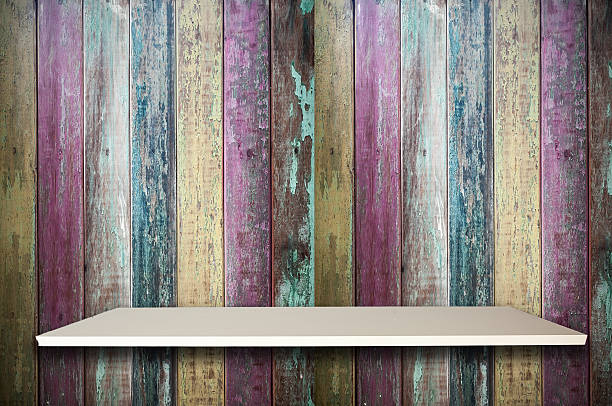 Empty top white shelves and colorful old wooden background