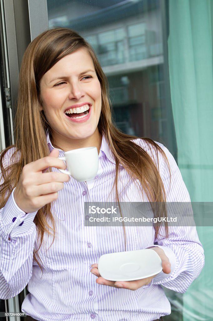 Home life Happy woman holding a cup of coffee and looking away 20-29 Years Stock Photo