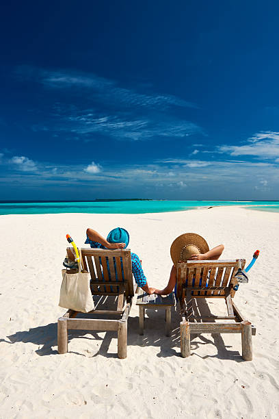 istock Couple relax on a beach at Maldives 537244033