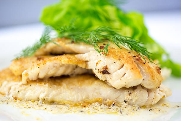 Sauted Filet of Sole Pan Sauteed Canadian White Fish garnished with Dill Weed. haddock stock pictures, royalty-free photos & images