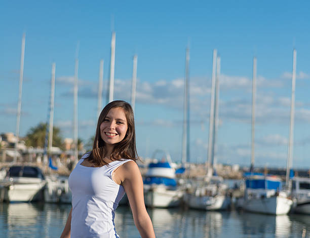 istock Young latin woman on harbor with sailing ships 537244775