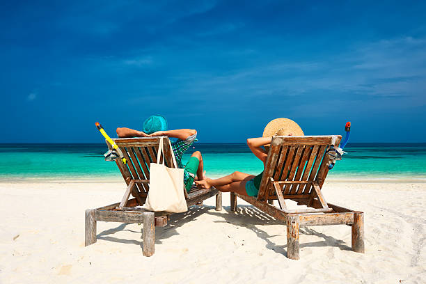 istock Couple in green relax on a beach at Maldives 537245615
