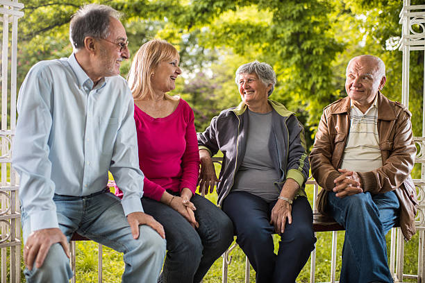 istock Happy senior friends relaxing in the park and communicating. 537245978