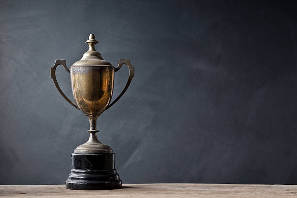 still life photography :  old trophy on old wood with space of art dark background