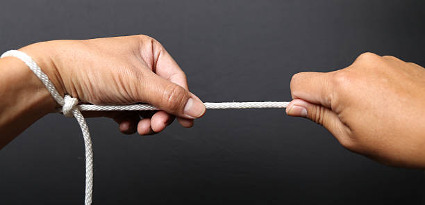 istock Hand holding a loop of rope for hanging. 537246404