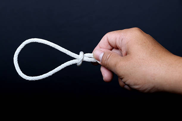 istock Hand holding a loop of rope for hanging. 537246460