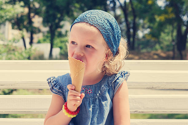 istock Funny little girl (3 years) eat ice cream. 537246892