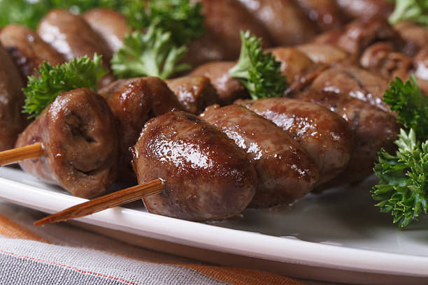 Grilled chicken hearts on skewers macro horizontal
