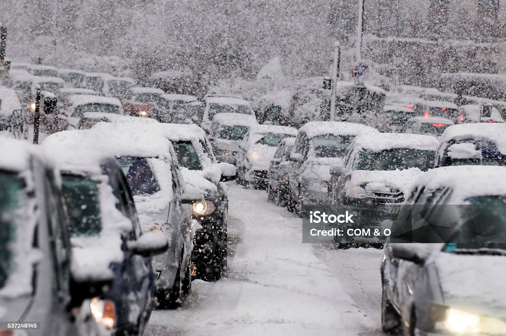 Traffic jam caused by heavy snowfall Cars driving on a highway are stuck in traffic because of a snow storm. Blizzard Stock Photo