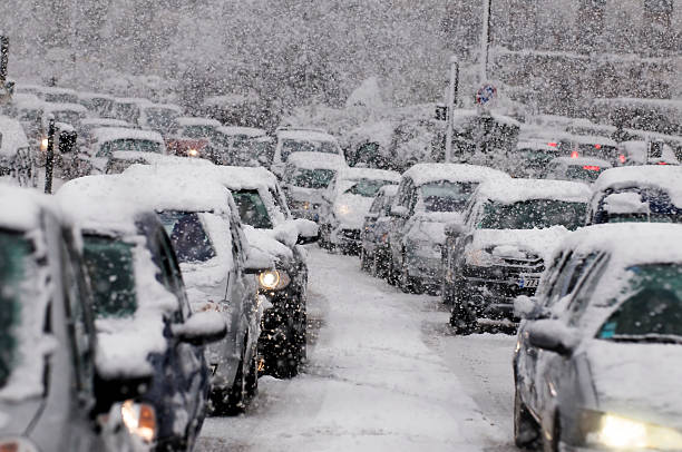 Traffic jam caused by heavy snowfall Cars driving on a highway are stuck in traffic because of a snow storm. blizzard photos stock pictures, royalty-free photos & images