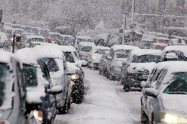 Traffic jam caused by heavy snowfall Cars driving on a highway are stuck in traffic because of a snow storm. car snow stock pictures, royalty-free photos & images