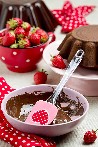 istock Chocolate cake. Decorating with chocolate icing and strawberries 537248182
