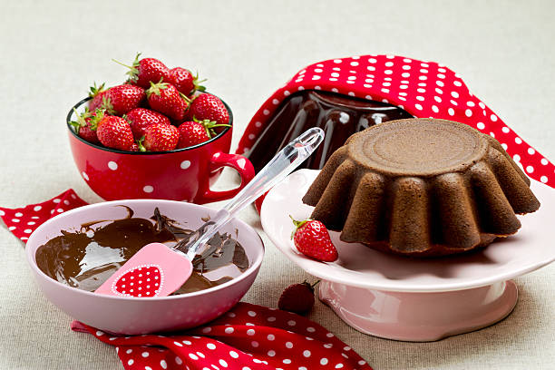 istock Chocolate cake. Decorating with chocolate icing and strawberries 537248368