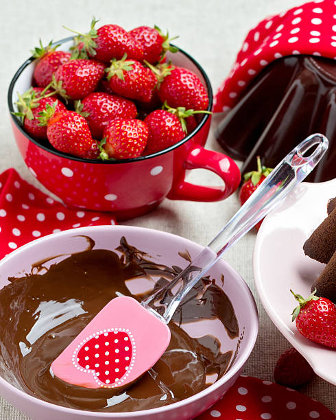 istock Chocolate cake. Decorating with chocolate icing and strawberries 537248432
