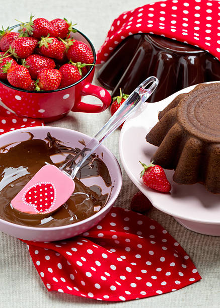 istock Chocolate cake. Decorating with chocolate icing and strawberries 537248526