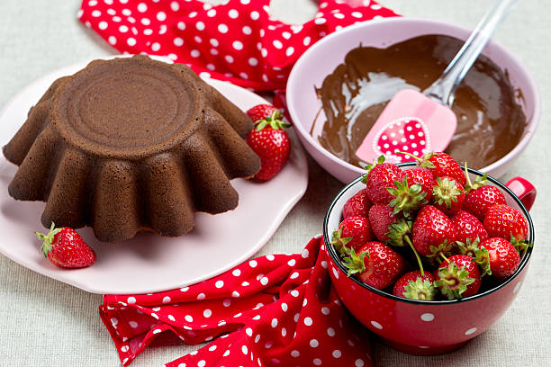 istock Chocolate cake. Decorating with chocolate icing and strawberries 537248714