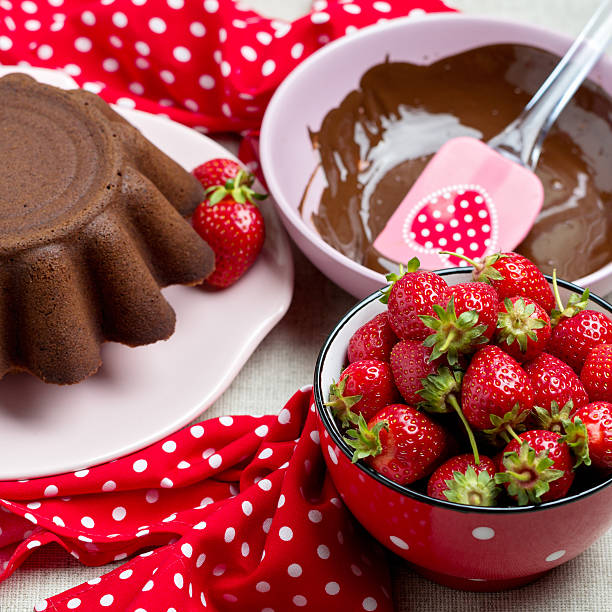 istock Chocolate cake. Decorating with chocolate icing and strawberries 537248768