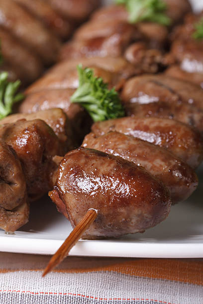 istock Grilled chicken hearts on skewers on a white plate close-up 537248825