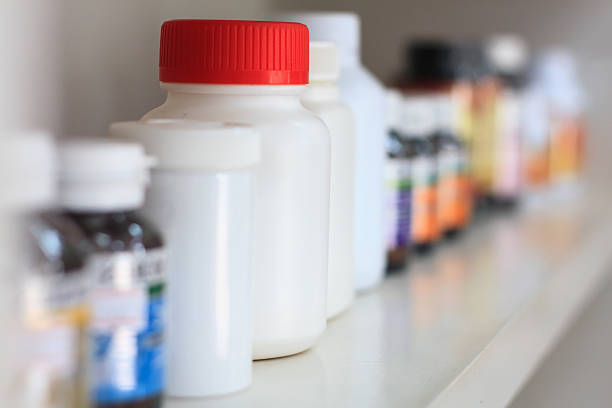 bottles on pharmacy store shelf medicine bottles on pharmacy store shelf over the counter meds stock pictures, royalty-free photos & images