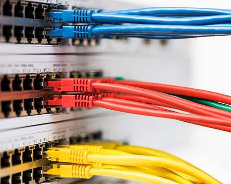 Closeup of  colored computer network cables  connected to a  switch