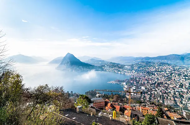 Panoramic view of Lake Lugano with light fog from Monte Bre, Switzerland