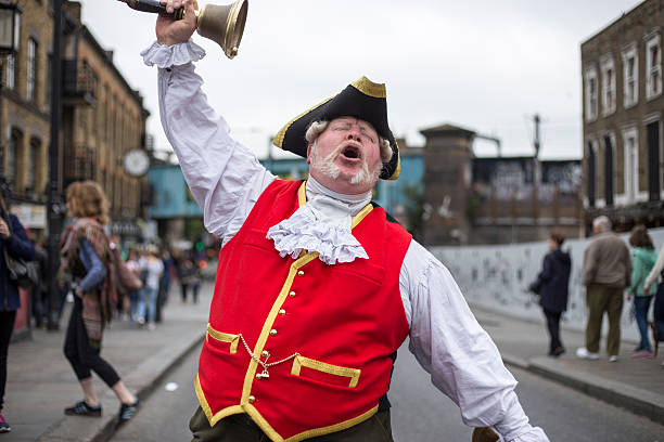 Town Crier, Camden London, United Kingdom - May 29, 2016: Town Crier dressed in traditional costume rings his bell and announces the news. town criers stock pictures, royalty-free photos & images