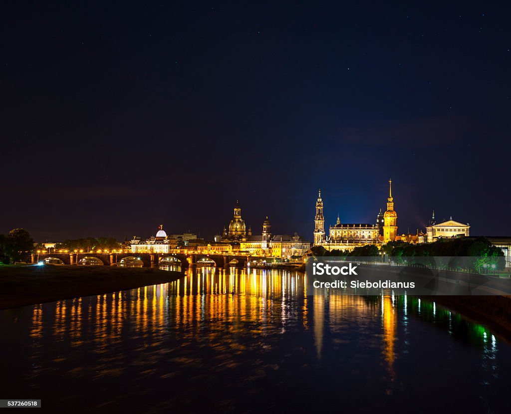 Dresden skyline at night with Theaterkirche, Frauenkirche, Hausmannsturm and Semperoper. Dresden skyline at night with Theaterkirche, Frauenkirche, Hausmannsturm and Semperoper. The skyline is reflected in the Elbe River in foreground. Capital Cities Stock Photo