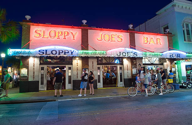 Duval street in Key West Key West, Florida, USA - May 01, 2016: Sloppy Joe's Bar in the twilight in Duval street in the center of Key West hemingway house stock pictures, royalty-free photos & images
