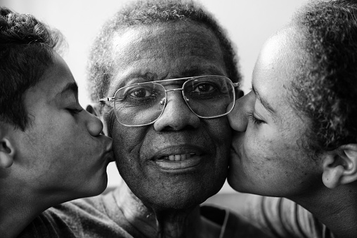 Children kissing their Grandfather.