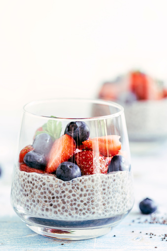 Homemade chia seeds pudding with berry fruit in the glasses,selective focus