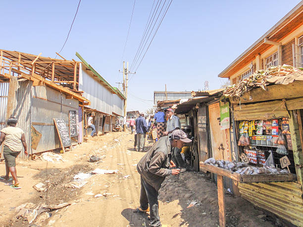 Men near small market on the street in Kibera slum Kibera slum, Kenya - September 16, 2013: Men near small market on the street in Kibera slum xxi stock pictures, royalty-free photos & images