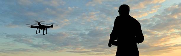 istock man operating of flying drone quadrocopter at sunset 537265960