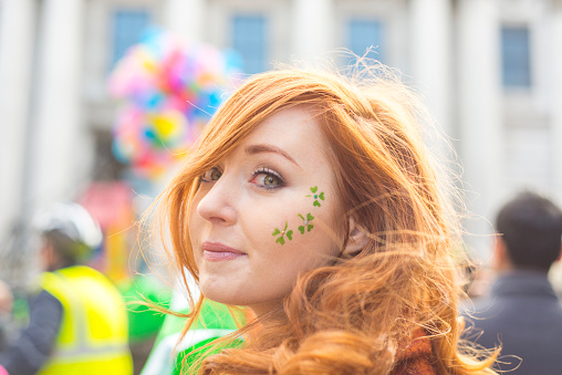 Beautiful red haired Irish girl enjoying the parade, Dame Street, Dublin, Ireland. 