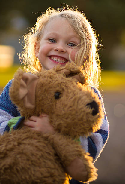 istock cute smiling child hugging a large teddy bear 537267528