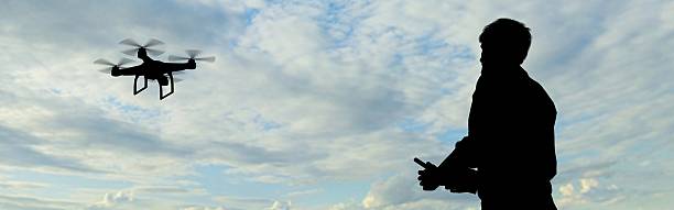 istock man operating of flying drone quadrocopter at the sky 537267968